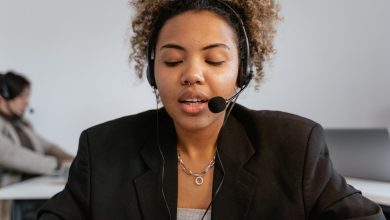 Atendente de serviço ao consumidor usa fones de ouvido em um ambiente profissional de atendimento.